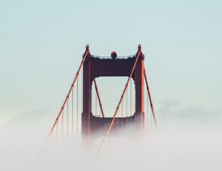 Top of golden gate bridge sticking out from thick fog