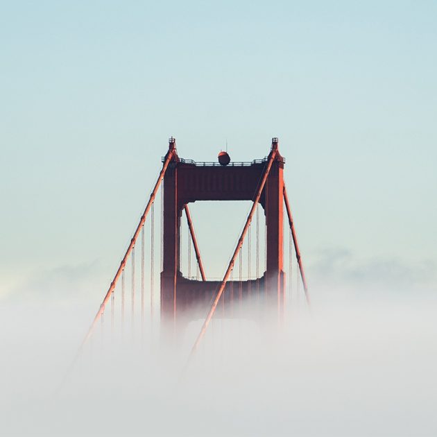 Top of golden gate bridge sticking out from thick fog