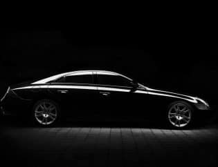 Silhouette of black sports car on black background