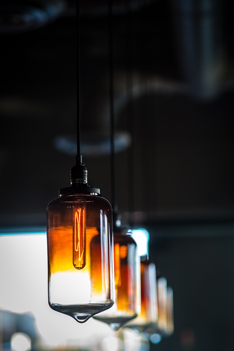Row of light fixtures hanging from a ceiling