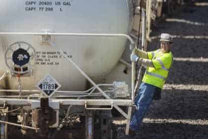 home-prod-bucket ERCO employee disembarking from back of train.