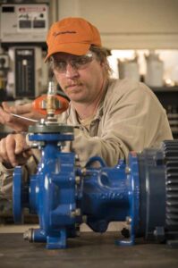 Motor technician repairing a small motor.