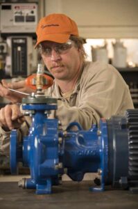 Motor technician repairing a small motor.