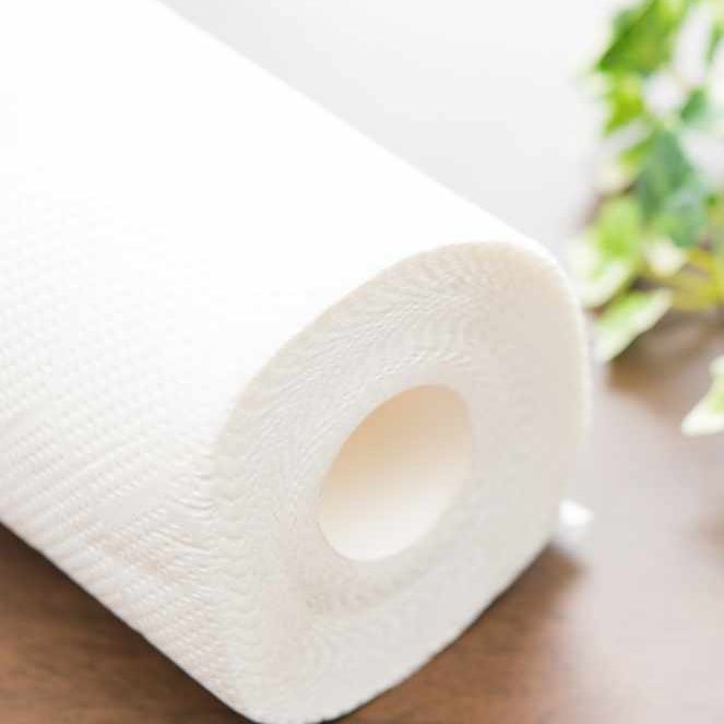 Roll of paper towel on wooden background