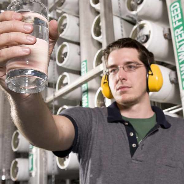 Water Technician Inspects Water at Public Utility Plant